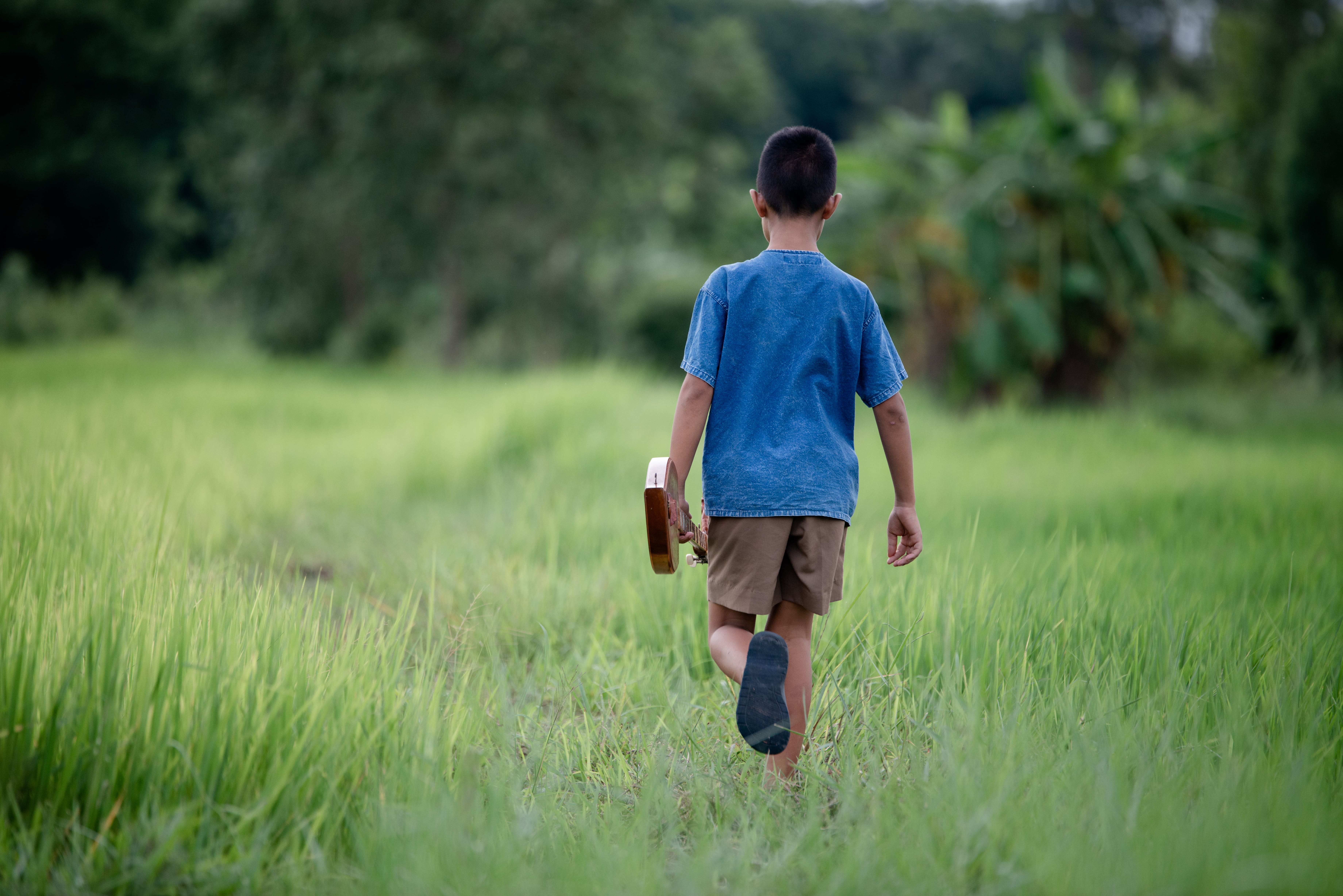 asian-young-boy-with-guitar-handmade-outdoor-life-country