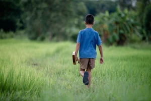 asian-young-boy-with-guitar-handmade-outdoor-life-country