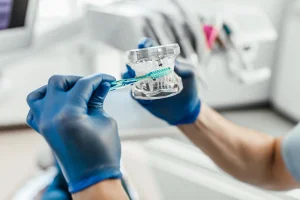 dentistry-models-human-teeth-manufacture-dental-prostheses-installation-implants-with-toothbrush (1)